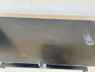 Black TV stand with glass shelves.