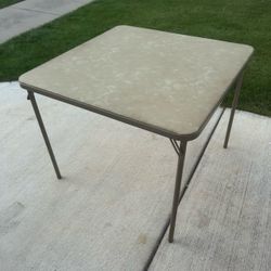 Square folding card table 34.5” x 34.5” with a textured vinyl top and collapsible metal legs