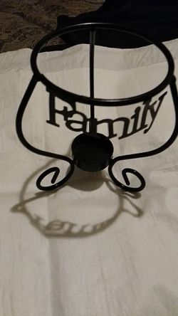 Candle holder. Reads family in big letters period black and ornamental Metal Violet candle or larger candle on top