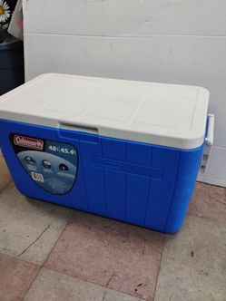 Coleman 48-quart blue personal cooler with a hinged lid. Has two handles and drainage plug