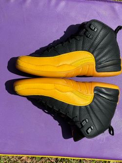 6y Nike Air Jordan 12 Retro University Gold sneakers featuring a black tumbled leather upper and yellow mudguards.