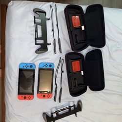Two Nintendo Switch With Started Kits, Docks, Controllers, Super Smash Bros, And Legend Of Zelda Breath Of The Wild.