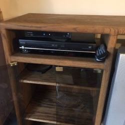 Oak cabinet with glass doors , 3 shelves With The Glass And  1 shelf underneath On Right , hole for tv Or Stereo Cabinet On Other Side 