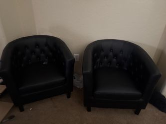 2 black tub style chairs