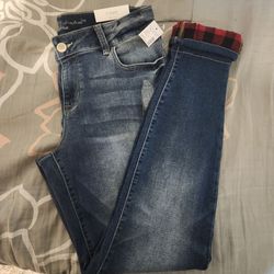 M Jeans by Maurices women's mid-rise skinny jeggings featuring a red and black buffalo plaid cuff.