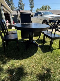 Black round Pottery Barn table chairs and leaf