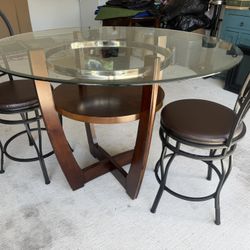 Glass top round wood table and 2 bar stools