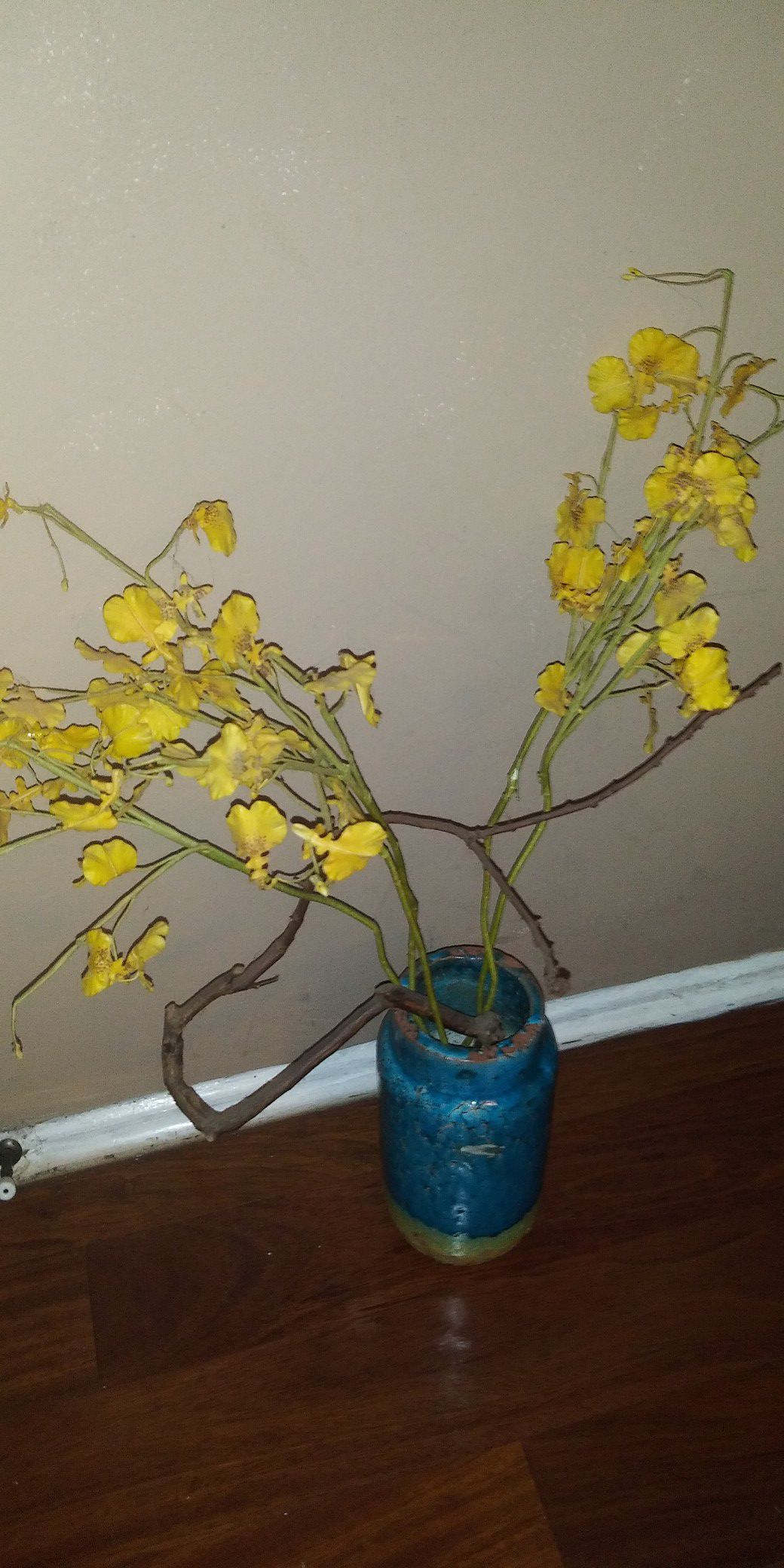 Silk flower arrangement in pottery vase