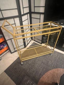 Better Homes & Gardens Fitzgerald Gold Metal Bar Cart with glass shelves.