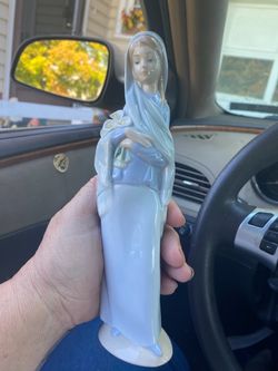 Lladro retired figure of girl with lilies(perfect condition)