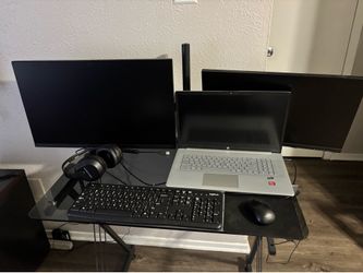 monitors and head phones desk chair keyboard and mouse