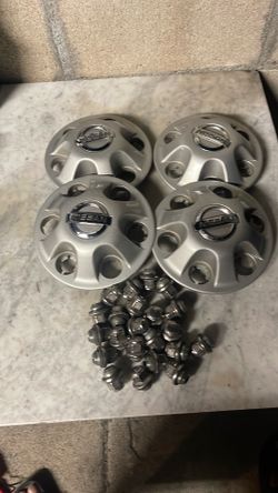 This silver Nissan wheel center cap is a genuine OEM