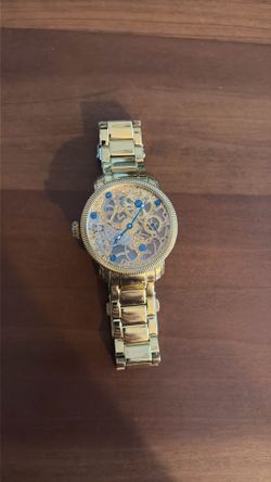 Akribos XXVI gold open face manual watch