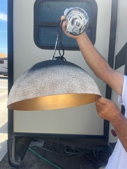 Hanging light .. I don’t know the brand. I think it’s from China. It is beautiful though brand, new t’s metal, black tan and gold brand new never used