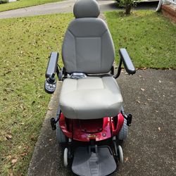 Red Jazzy power chair with joystick control. 
