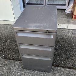Metal filing cabinet with three drawers,