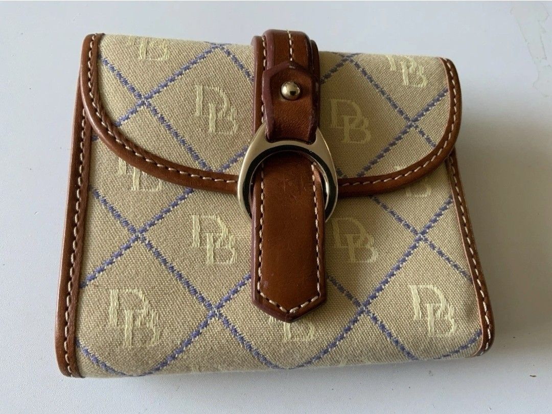 Dooney & Bourke Vintage Monogram compartment wallet is in excellent condition, gently used with little to no wear whatsoever. Faux buckle at the front
