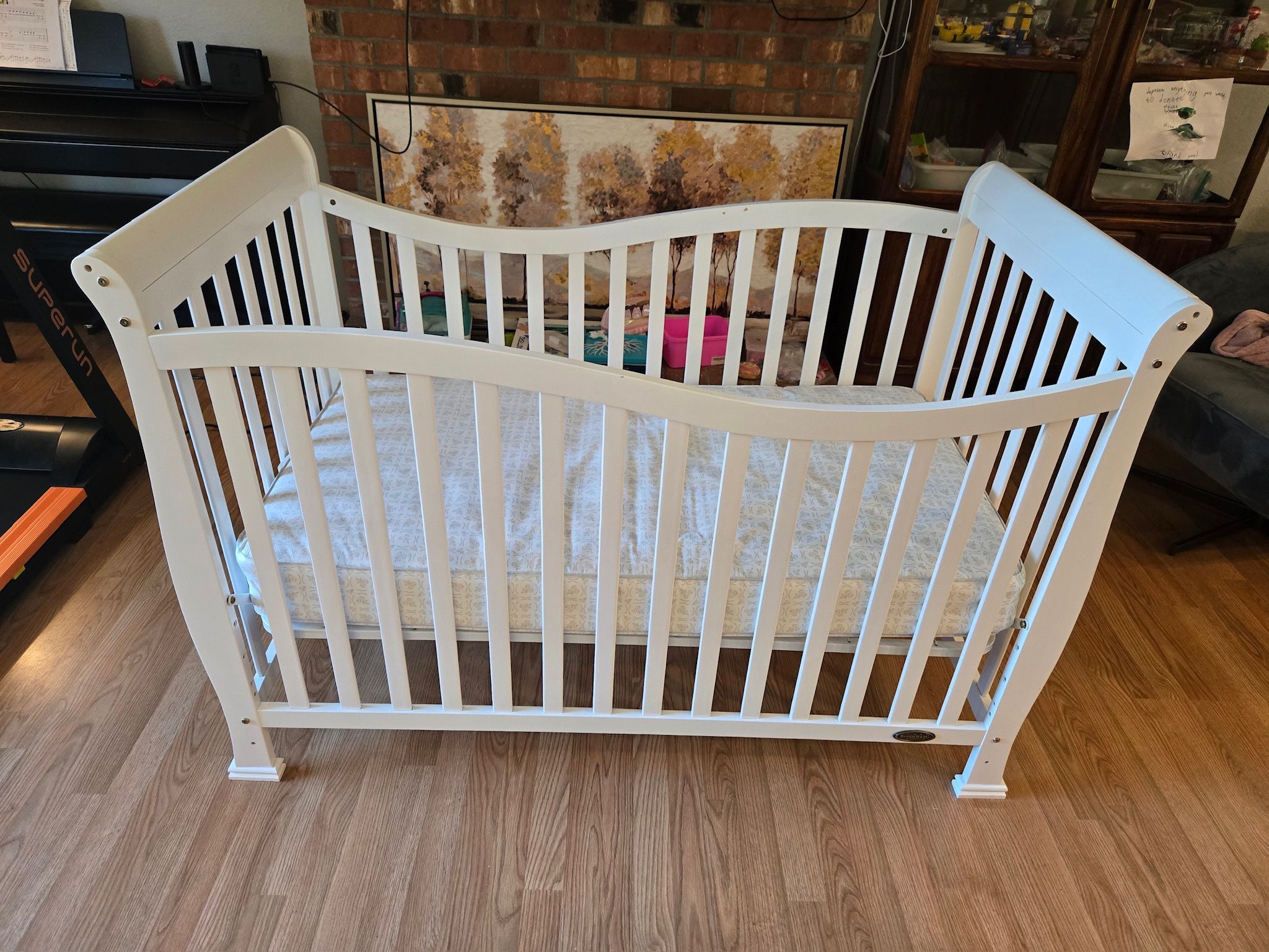 White crib with waterproof mattress