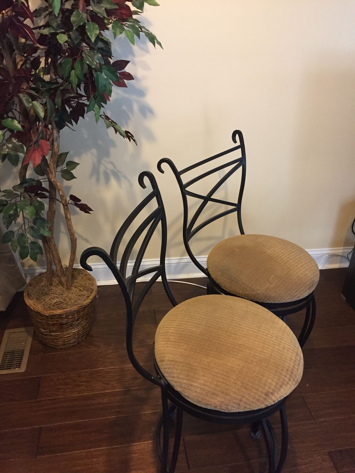 2 Black framed bar stools with beige padded seats