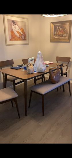 Wood dining room table with chairs and bench