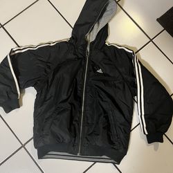A Black Adidas Young Boys Reversible jacket. 