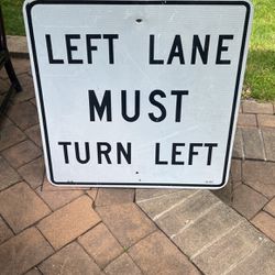 Street sign. Left Lane must turn Left  Porch Pickup 