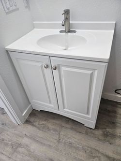 White vanity with sink and faucet