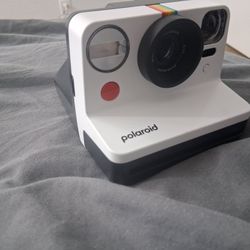 Polaroid Now Instant Camera, most likely a Generation 2 model, in the "Black & White" or "Panda" color scheme. 
