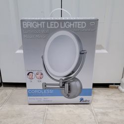 brand new bright led lighted cordless wall mount mirror. (MUST SELL TODAY)