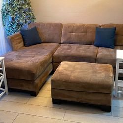 Living room brown L shape sectional couch set with two end tables.