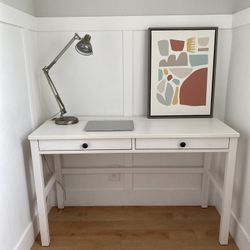 Pre-owned Ikea white Hemnes desk with two drawers and opening for cord storage.