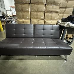 Faux leather sofa that Adjusts To Day Bed 