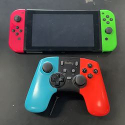 Nintendo switch with pink and green joycons and extra controller
