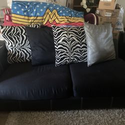 Black Couches W/ Pillows & Coffee Table 
