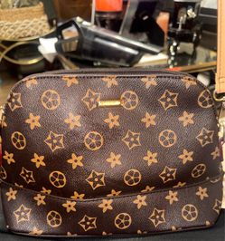 Approximately 12x7 The handbag shown is Preowned from the brand Elim & Paul. It features a brown monogram print with gold-toned hardware, a style ofte