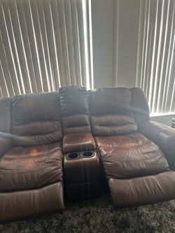 Leather brown sofas and small tables