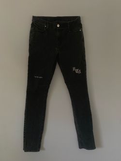 RtA (Road to Awe) grey-washed denim jeans featuring a black brand