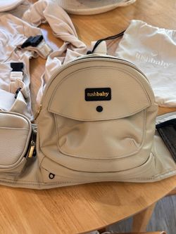 Tushbaby hip carrier with baby attachment