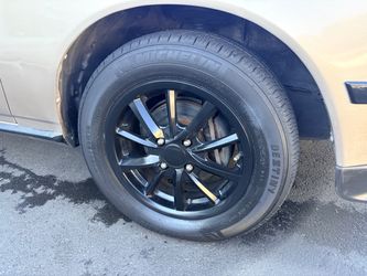 4X100 . 4 lugs glossy black rims and tires