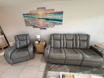Gray leather power, reclining, couch, and matching grey leather power recliner