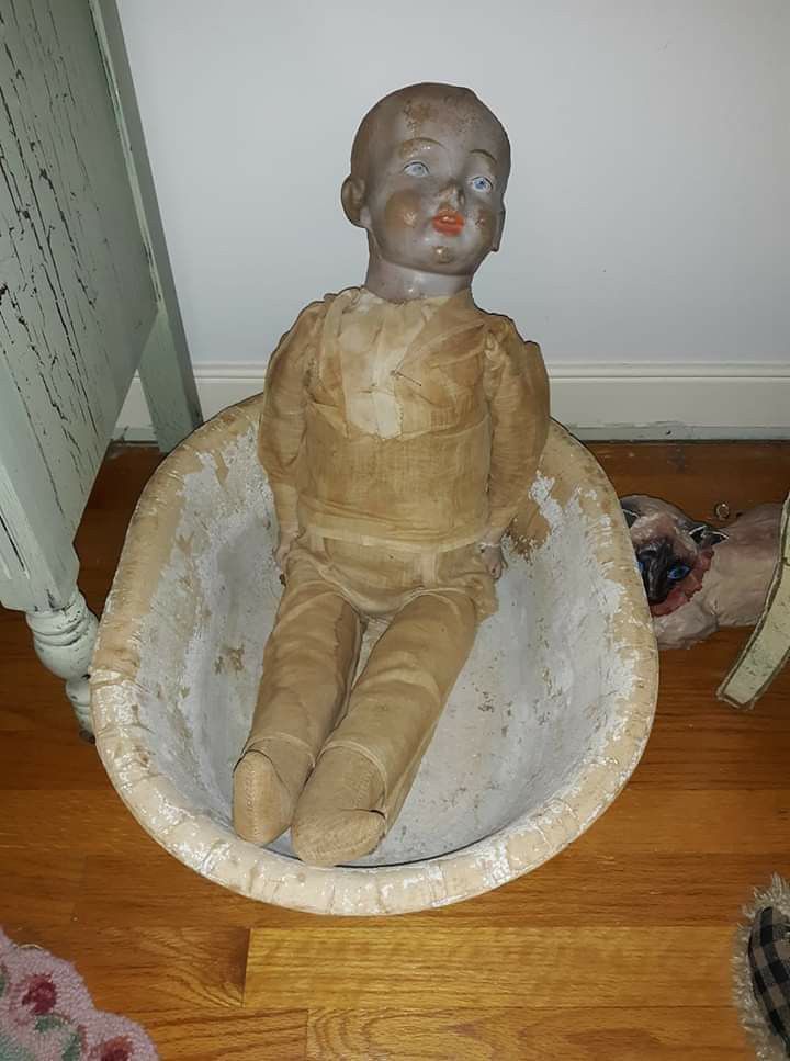 Very large antique doll in antique basin