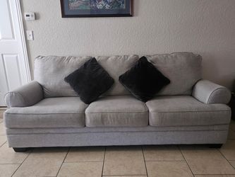 Light gray 3-seater sofa with Gray toss pillows