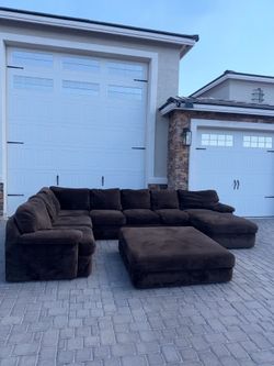Brown 3 piece sectional with ottoman