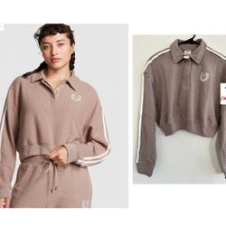 PINK REVERSE FLEECE CROPPED POLO SWEATSHIRT XS  The Takeaway: Puts some prep in your step Sporty stripes and a cropped silhouette kick this classic pi