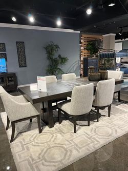 Clean-lined and modern dining set features double pedestal & thich table top