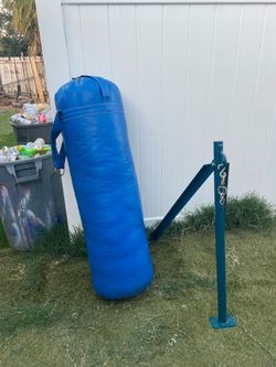Boxing bag and several different weights like plates and dumbbells