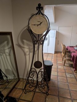 Howard Miller Wrought Iron Grandfather Clock With Rock Face