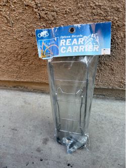 Deluxe Bicycle Rear Carrier," likely a vintage chrome "rat trap" style rack similar to those made by Schwinn or Raleigh.