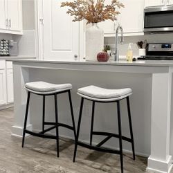 Pair Of Nathan James Arlo Gray Upholstered Counter Height Saddle Bar Stools With Black Metal Base