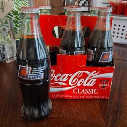 Six-pack of vintage 8 oz. Coca-Cola Classic bottles commemorating the 1993 Western Conference Champions Phoenix Suns basketball team. 